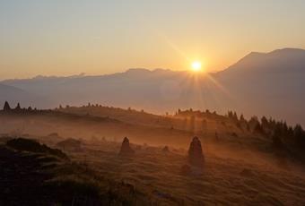 Mystical atmosphere at sunrise at the Stone Men above Vöran in South Tyrol